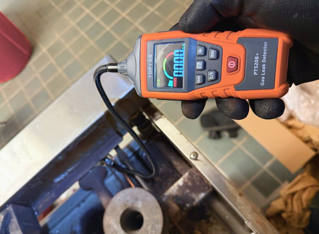 Appliance Rescue Team technician checking a commercial stove for gas leaks with a calibrated electronic detector