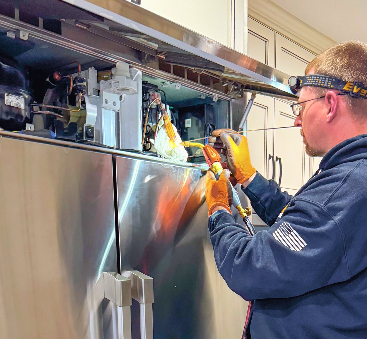 Appliance Rescue Team technician brazing a refrigerator sealed system during a repair in Bergen County, NJ