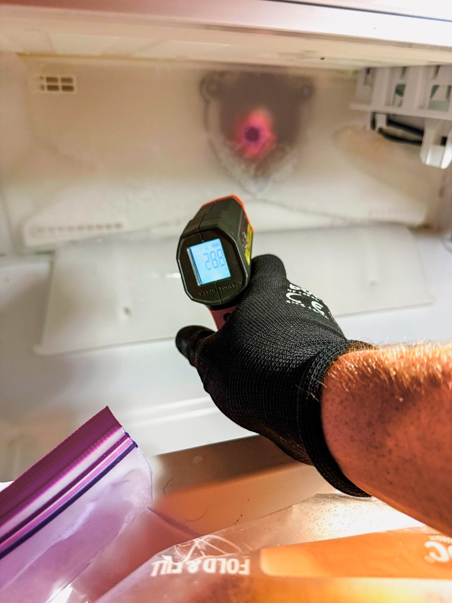 Appliance Rescue Team technician checking a refrigerator's temperature with an infrared thermometer — Appliance Rescue Team serves Cresskill, NJ