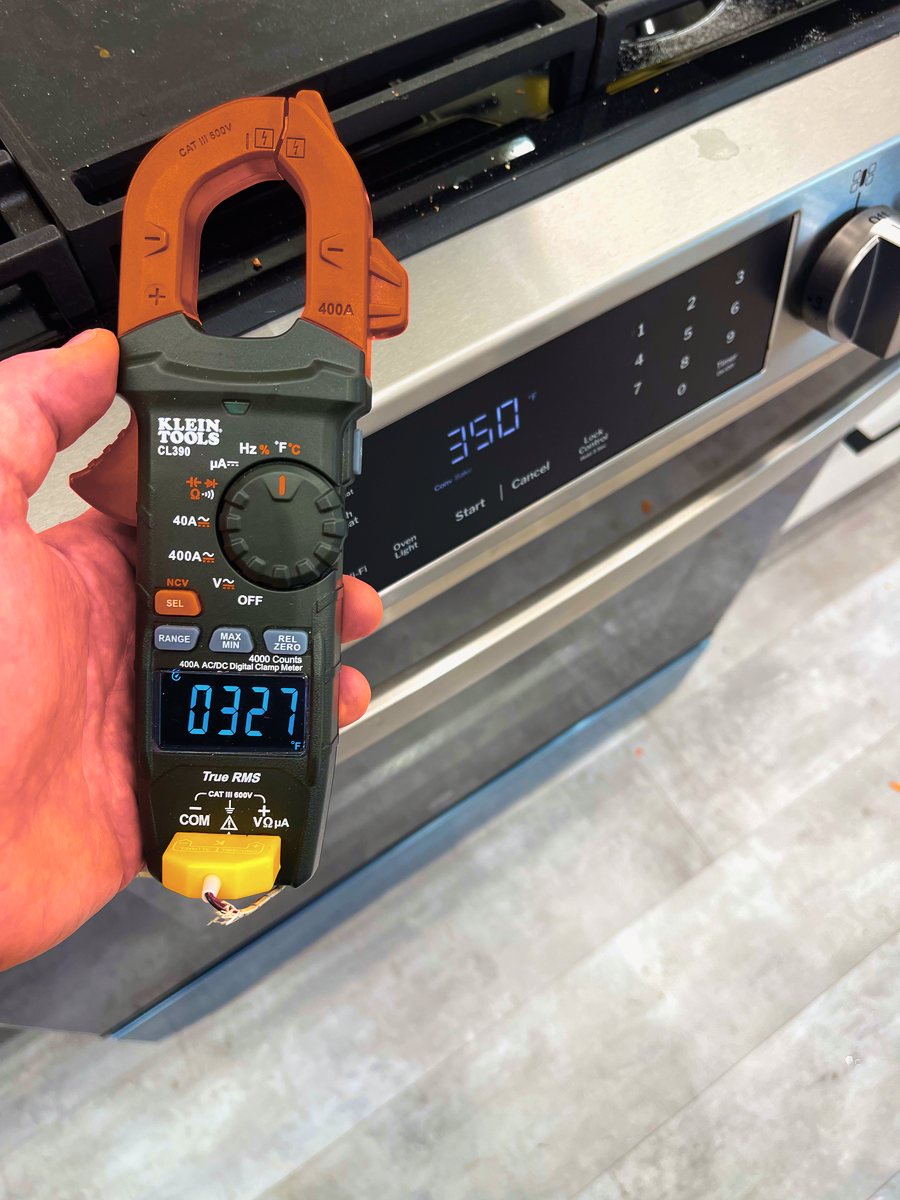 Appliance Rescue Team technician checking oven temperature calibration with a probe thermometer