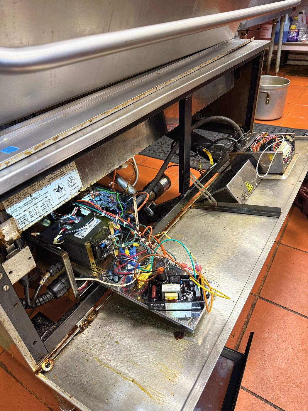 The control compartment open — transformer, ignition module, relays. The supply that drives the tilt is in here, nowhere near the gas side of the machine
