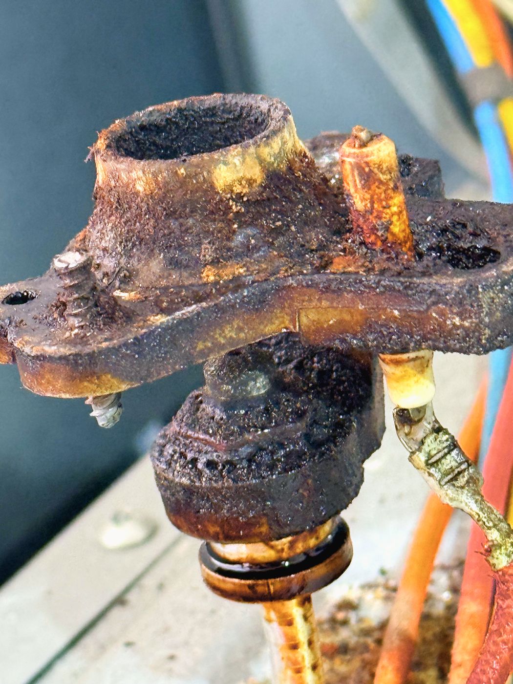 One of the burner bases out. Corroded through, ports packed, and the wiring below it in the same state