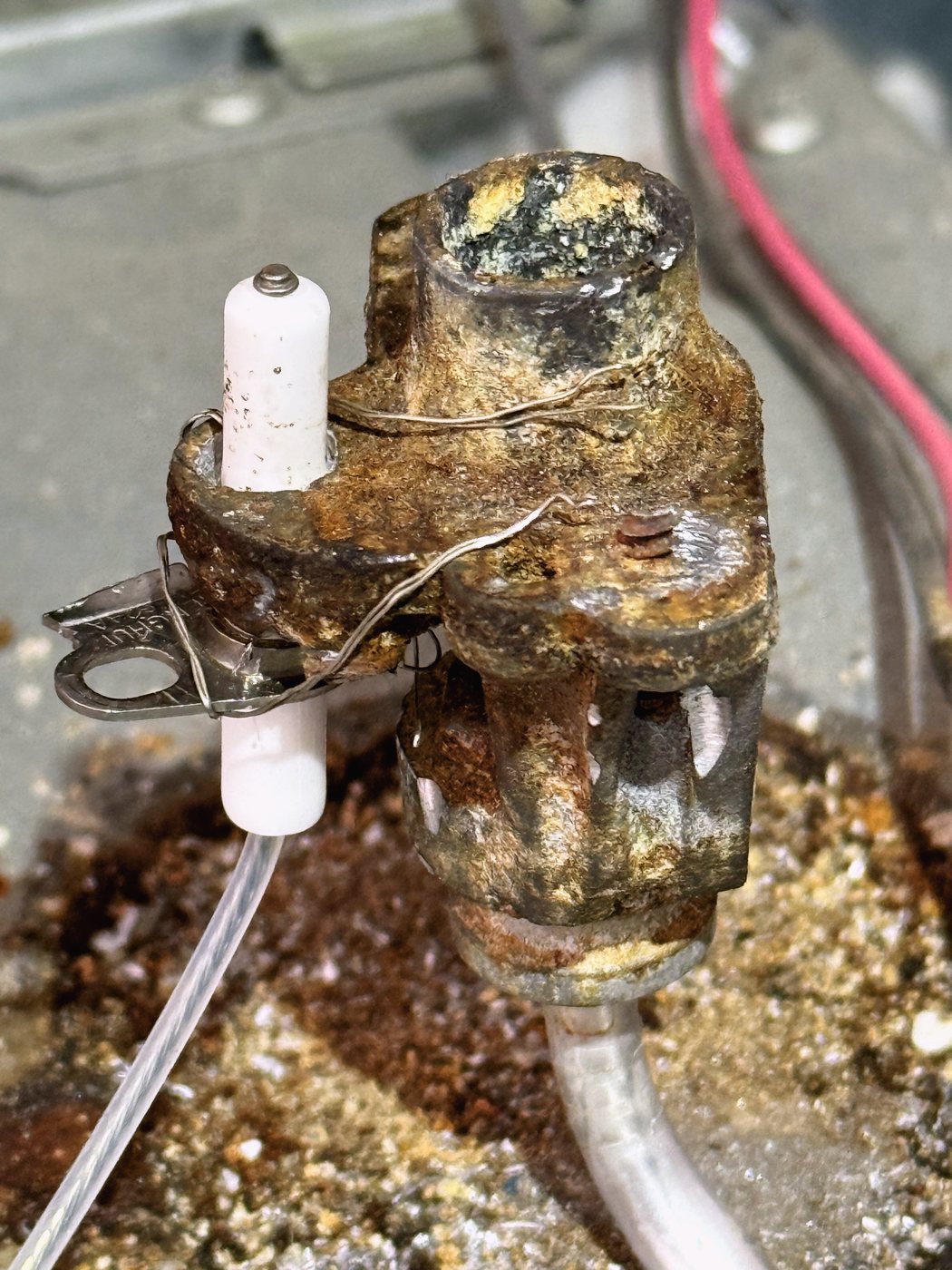 Someone had been here before us: an igniter held to the burner with a twist of ordinary wire instead of its bracket