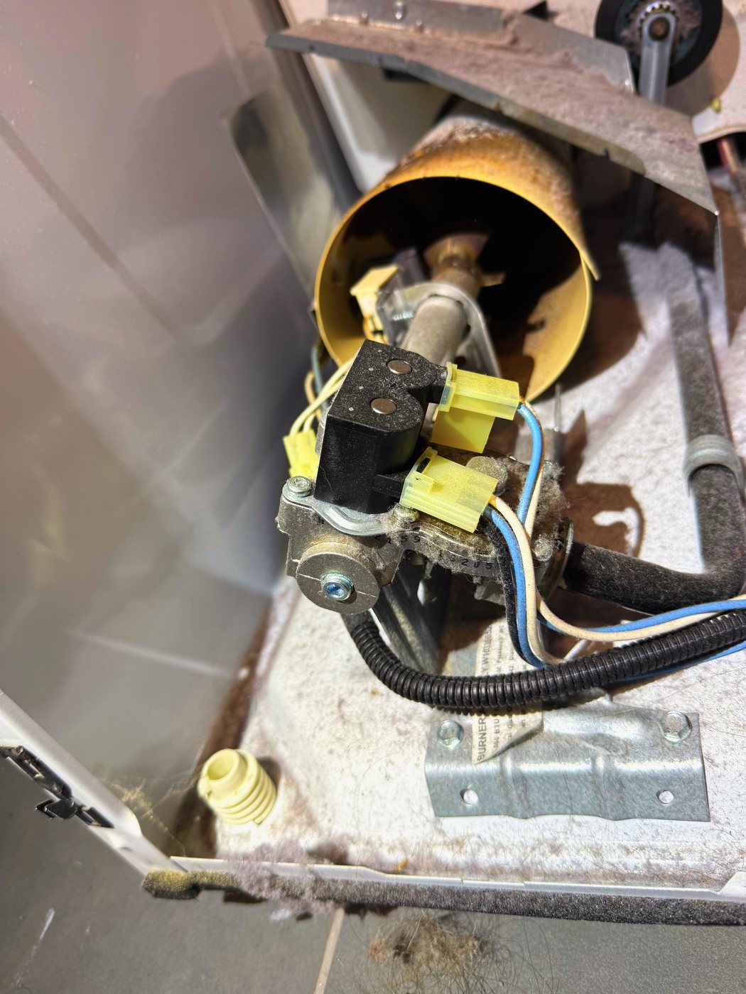 The burner assembly in place, with the gas valve and its coils on top. This is what feeds the flame
