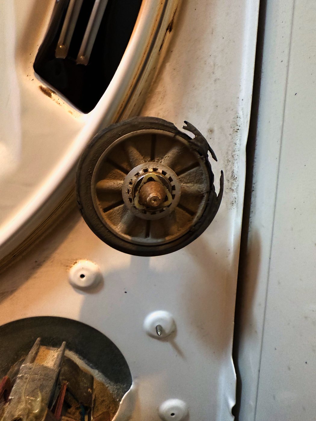 One of the two drum support rollers, still in place. Part of the rim has broken away — that missing piece is the banging
