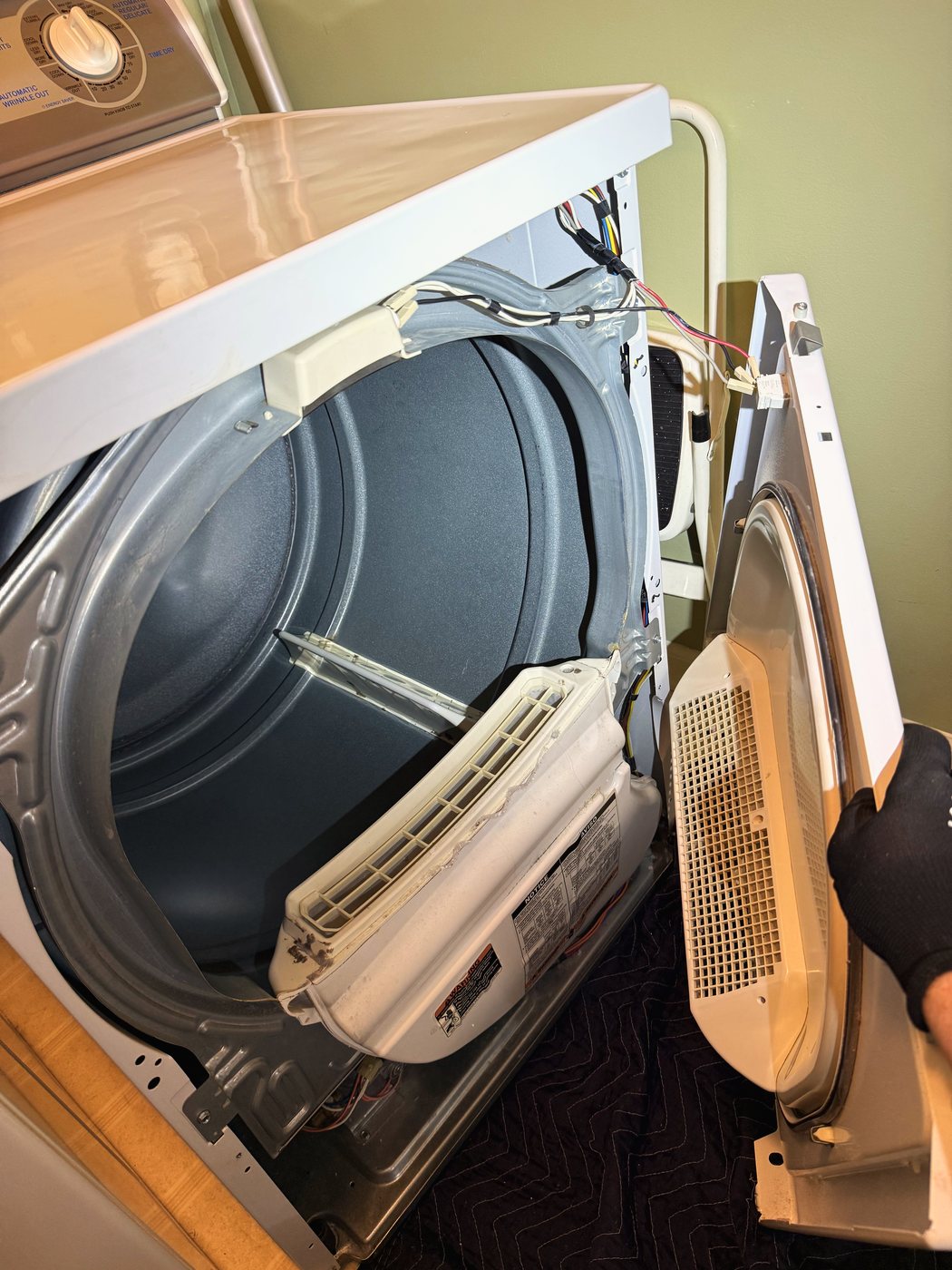 The lint duct out during the service. Opening the machine is most of the work — checking the rest of it while you are in there is the cheap half
