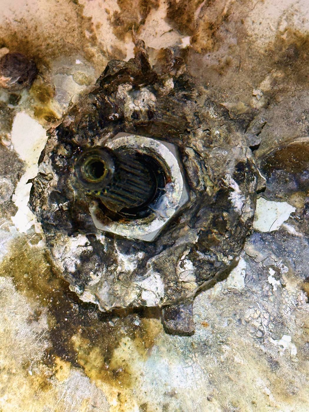 The hub itself, close up. What should be solid metal has turned to layers of rust that break away under a fingernail