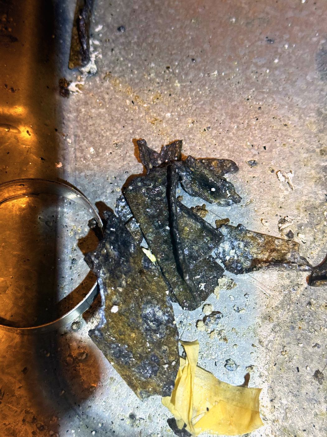 Pieces that had broken off the hub, laid out. This is what the drain line was being asked to pass
