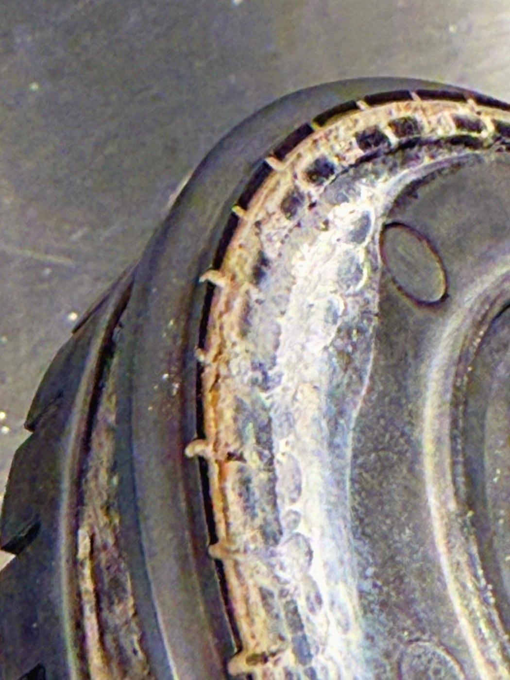 The lower tier up close, silted up. Those ports are barely wider than a pin, and this is where the small flame should sit