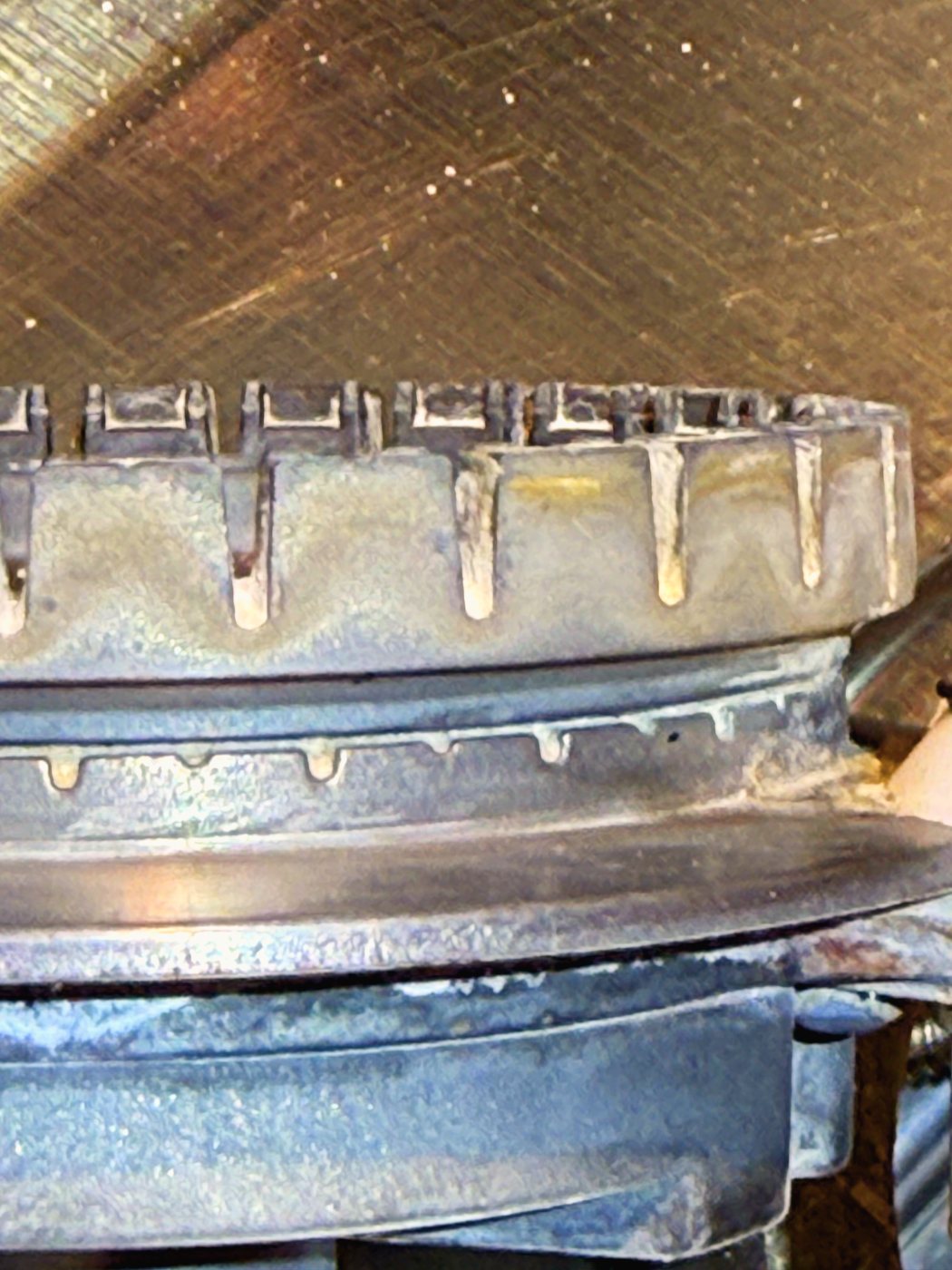 Both tiers in one frame: the wide slots you cook on above, and below them the fine ports that keep the flame signal alive